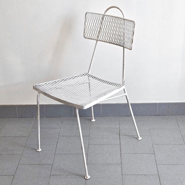Fair condition, signs of wear, typical chips in the white lacquer and oxidation. The front right leg of one chair is...