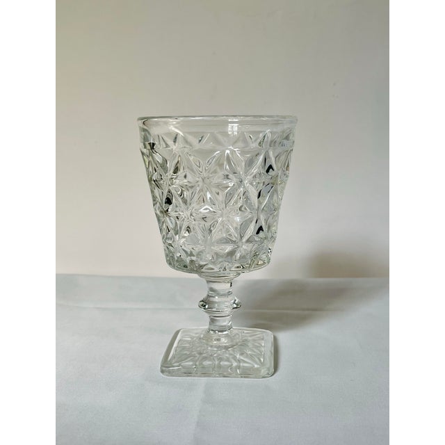 A pair of square footed water goblets in a faceted geometric pattern. Ships within 1-2 days using USPS. All items packed...