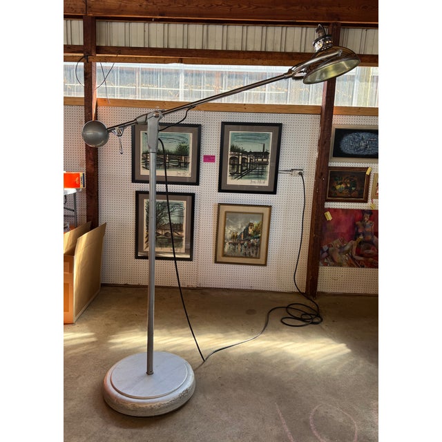 Mid-century industrial floor lamp by Wilmot-Castle, circa 1959. The boom arm is balanced by a solid ball counterweight,...