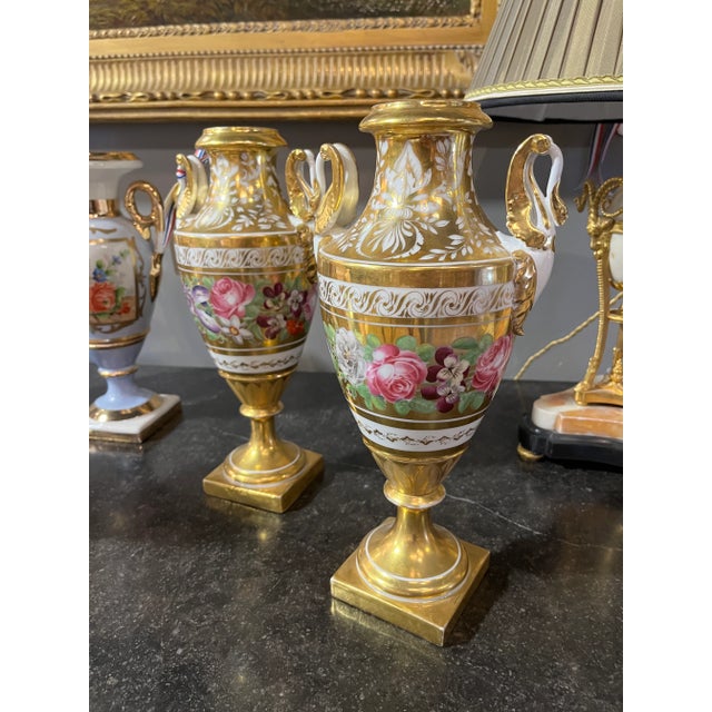 Circa 1800 Pair of Floral Paris Porcelain Urns. Beautiful pair of Urns purchased in France. Age appropriate wear, see...