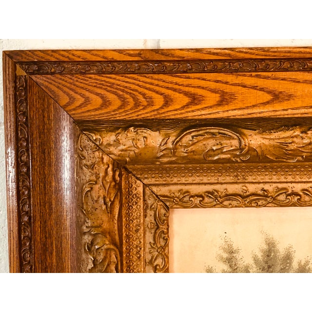 Vintage 1890s Oak wood frame with gold wood accents. The frame comes with a print of a horse drawn carriage with a cabin...