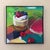 This artwork features a luscious cheesecake topped with fresh strawberries and blueberries, set against a vibrant,...