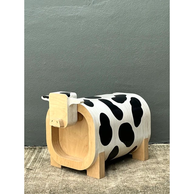 This vintage sculptural wood cow low stool blends folk art whimsy with everyday function. Crafted from solid wood, it...