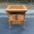Charming vintage side table featuring an inlaid checkerboard/chessboard top in warm, honey-toned woods. The square top...