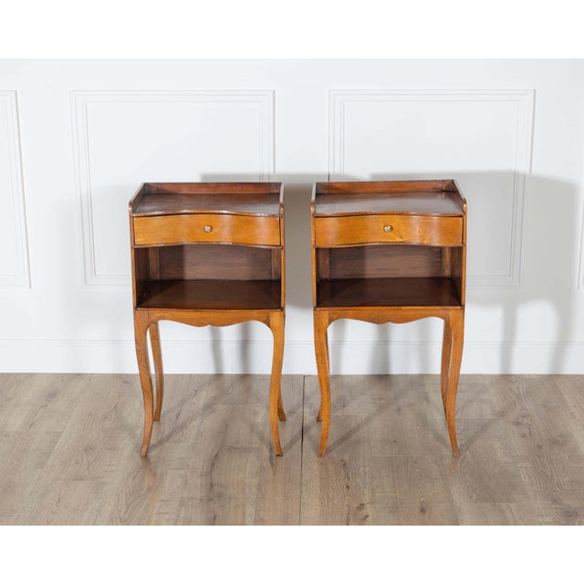 This charming pair of Louis XV style bedside tables captures the warmth and elegance of classic French design. Crafted in...