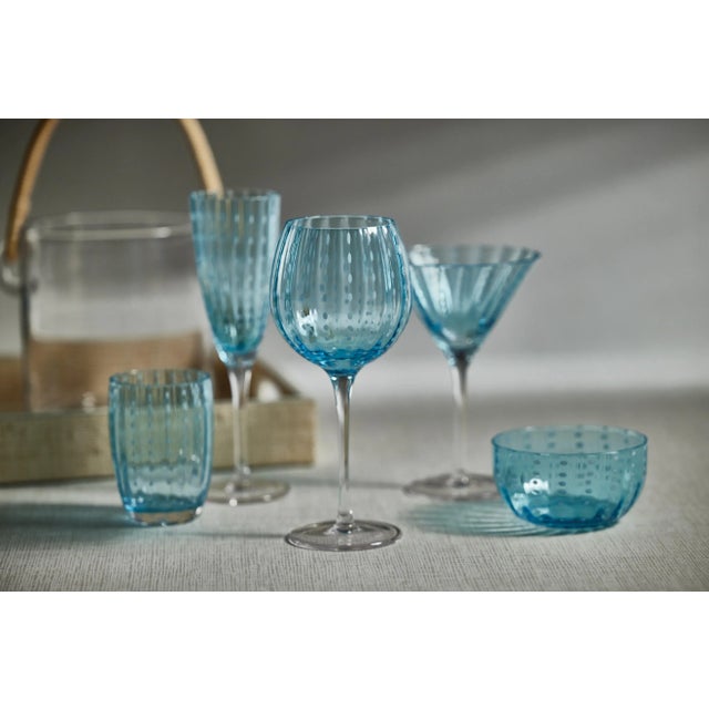 Spice up your dinner parties with glasses that shine. This set of 4 champagne flutes features colored glass with white...