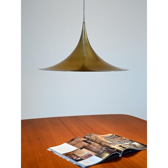 Danish brass pendant lamp with a white interior, attributed to Claus Bonderup & Torsten Thorup for Fog & Mørup. Clean,...