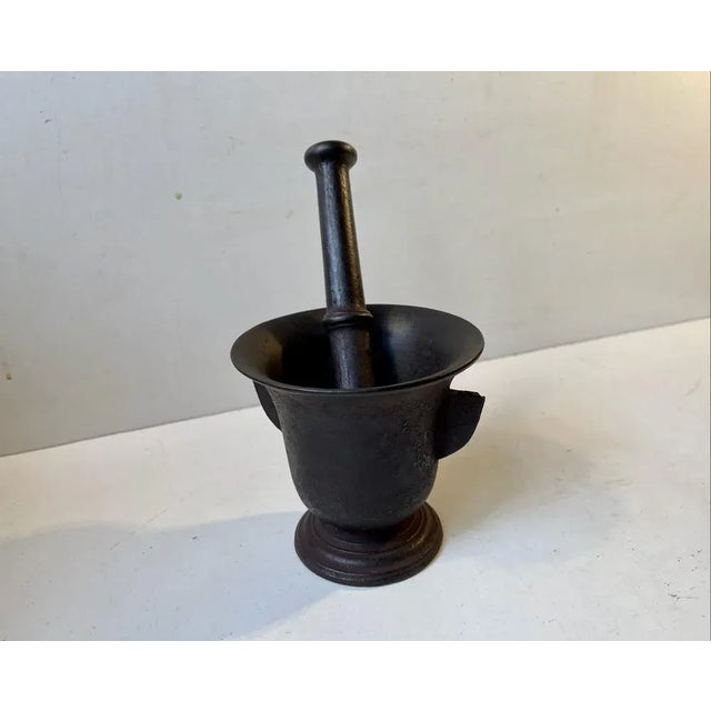 Finely proportioned, medium sized cast iron mortar and pestle. With its original finish and excellent patina. Nice and...