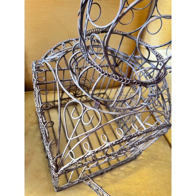 This is a unique and ornate vintage metal birdcage. Hinged door on front which has a metal closure. The top is also easily...