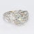 This is a vintage platinum art deco style ring with sixteen accent diamonds surrounding the ~0.8ct Old European Cut...