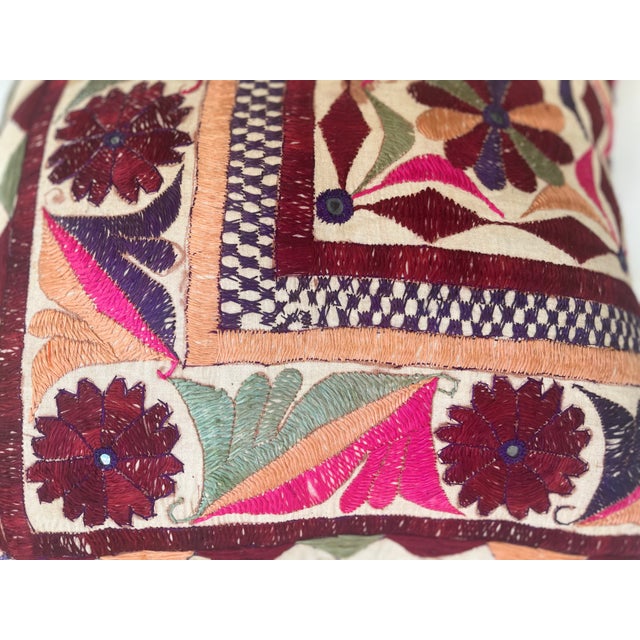 Elegant decorative pillow upholstered in a richly patterned Uzbek textile, featuring charming floral flowerhead motifs and...