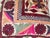 Elegant decorative pillow upholstered in a richly patterned Uzbek textile, featuring charming floral flowerhead motifs and...
