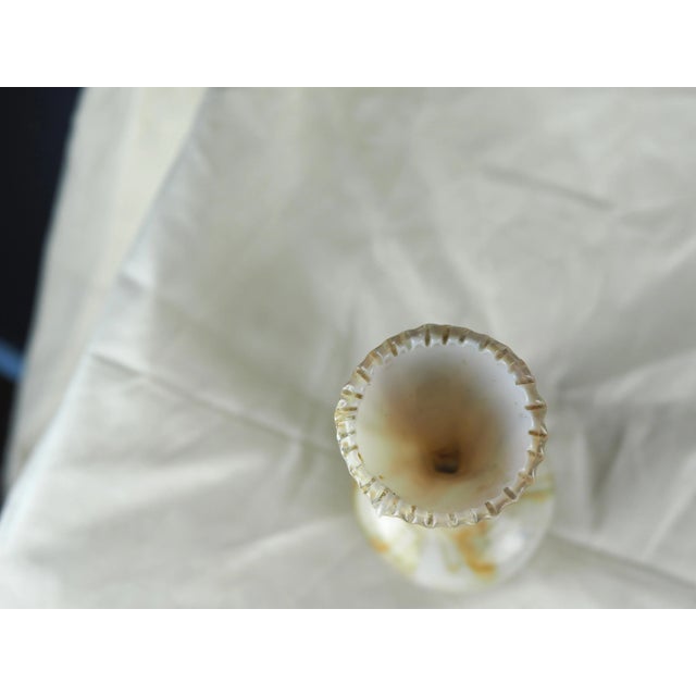 Blown glass vase with serrated neck, marbled white with gold inclusions. This magnificent vase is a piece of art that can...