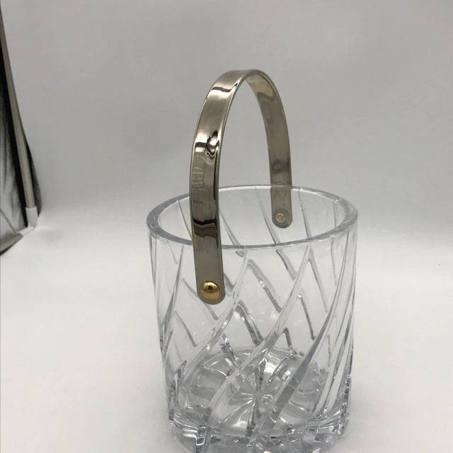 This is a lovely, light catching cut crystal ice bucket with deep swirl cuts in the glass. Made by Mikasa in the Olympus...