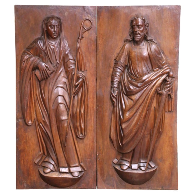 Carved in France circa 1680, this important pair of ecclesiastical walnut panels depicts Saint Paul the Apostle and Saint...