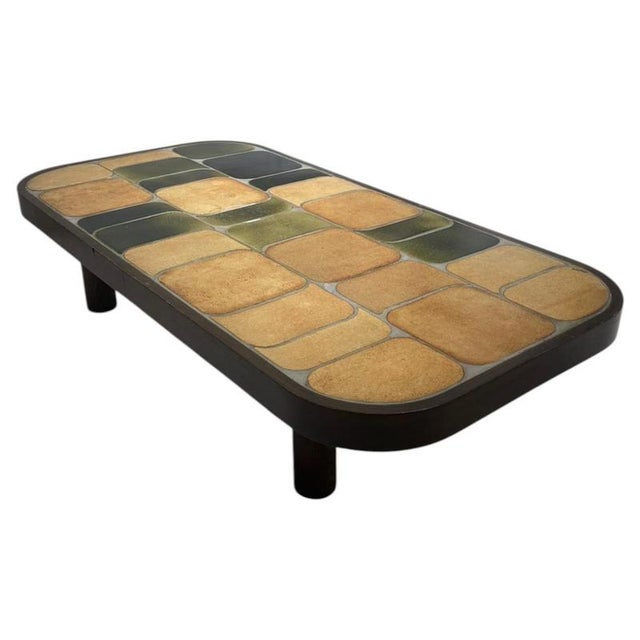 Large “Shogun” coffee table by Roger Capron, dating from the 1960s. The table features a substantial dark wooden structure...
