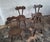 Set of 4 hand-crafted Brutalist elm or oak chairs after Alexandre Noll, France 1950s. 2 of the chairs are tripod chairs, 2...