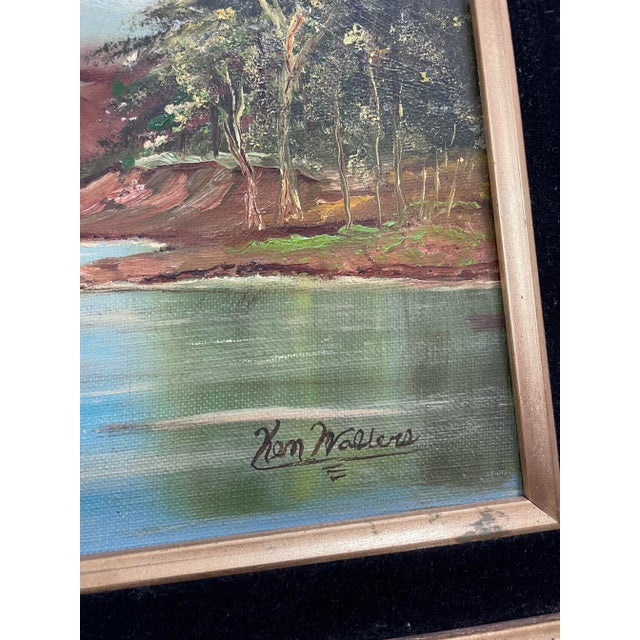 A dynamic mountain landscape scene with water, trees and snowy mountains done in oil on board in a vintage frame. Signed...
