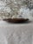 Sculptural contemporary serving tray in a rich chocolate brown ceramic finish with softly irregular edges and an organic...
