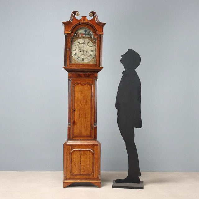 A Burton & Pattison oak pendulum clock from Halifax, with mahogany inlays and maple trim. Engraved metal and worked sheet...