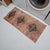 This authentic hand-knotted small Turkish rug showcases a beautifully distressed aesthetic that effortlessly adds...