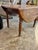 Antique wood drop leaf dining table features turned legs and a distinct grain pattern, resembling farmhouse or Victorian-...