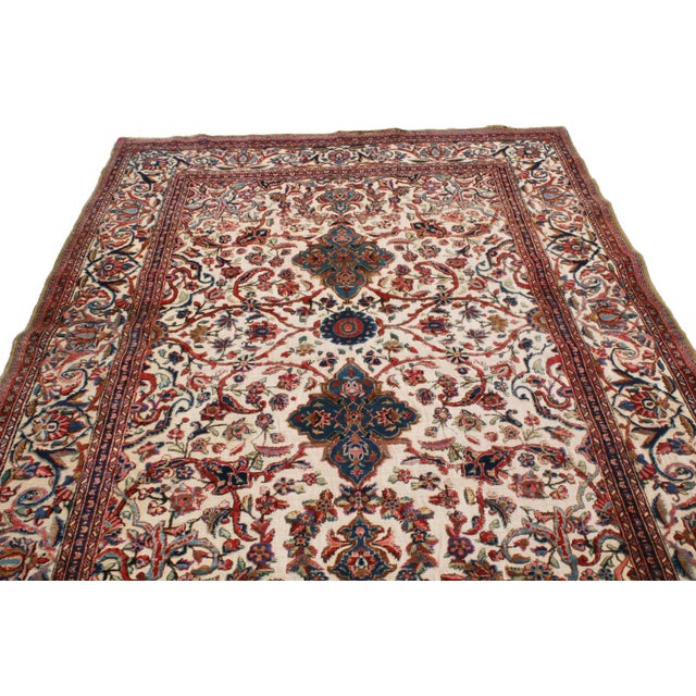 Enjoying pristine, hand-knotted silk originating from Persia in 1900, this antique Kashan rug marries the intricacy of...