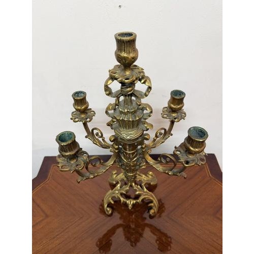 Striking late 19th century French Napoleon III revival candelabra crafted in gilt brass. This elegant piece features a...