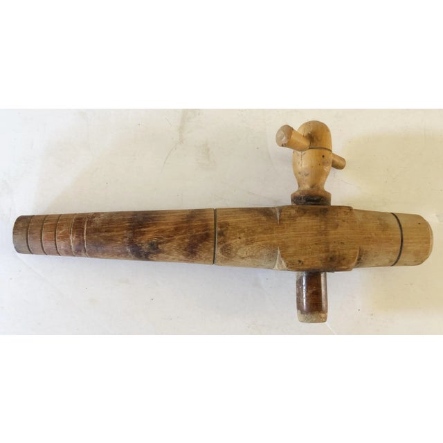 This French carved wooden spigot was used for dispensing wine from a keg. The thumb valve rotates to release the flow of...