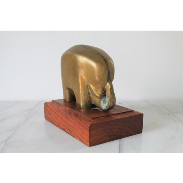 Vintage brass elephant on wood stand. No makers mark. Minor age wear, some patina.