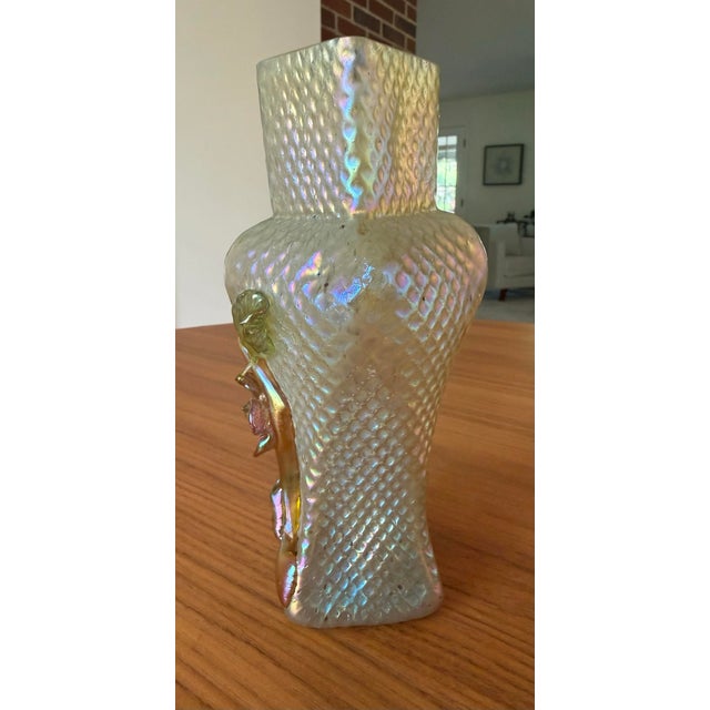 A captivating piece of early 20th century decorative glass, this vase glows with the kind of rainbow iridescence that made...
