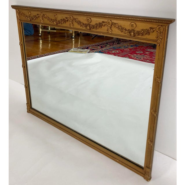Large antique Art Nouveau style carved gilt wood framed wall or mantle mirror. This piece has a quiet elegance with great...