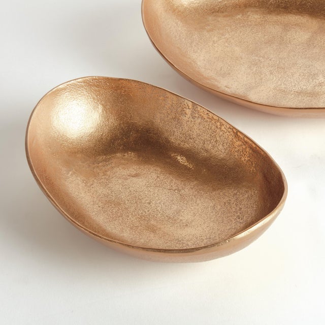 This pair of handcrafted bowls has simple oval silhouettes, with a warmGold finish and subtle texture. They can be styled...