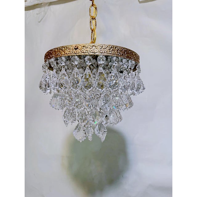 Introduce romance and rich vintage texture to your home with this enchanting mid-century tiered brass French pendalogue...