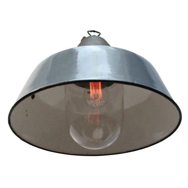 Industrial factory hanging lamp in grey enamel with white interior. Clear glass, cast iron top. e26 / e27 all our lights...