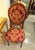 Elegant and richly detailed, this French Louis XVI style chair features a refined burgundy damask upholstery adorned with...