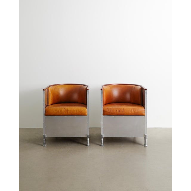 A rare and special commissioned pair of mats theselius aluminium armchairs with dark brown beech armrests and beautifully...