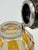 A striking vintage glass inkwell featuring an octagonal cut glass body with warm yellow amber panels and delicate etched...