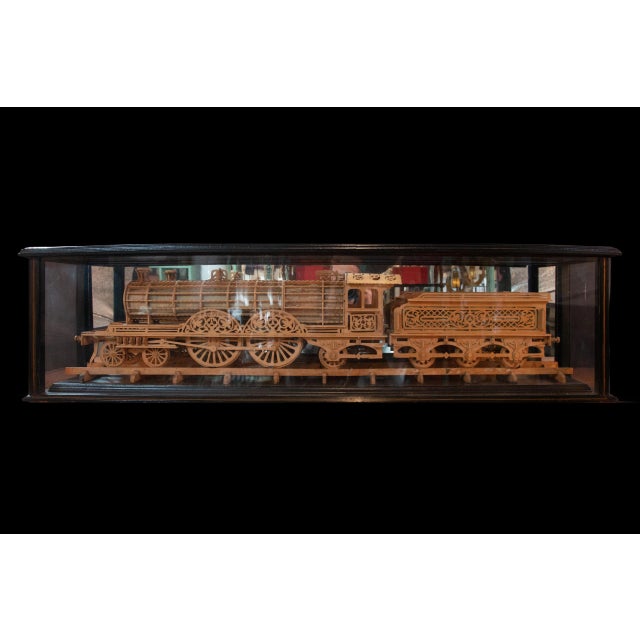 Carved Wood Model of a Locomotive showcased in a glazed and painted wood case. This intricately crafted piece captures the...