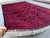 This finely woven Khamyab rug features a dense diamond lattice of octagonal medallions in deep navy, each centered with...