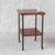 Wheeled serving trolley. Brown lacquered metal frame with two teak veneer shelves. Stable and sturdy, weighs approximately...