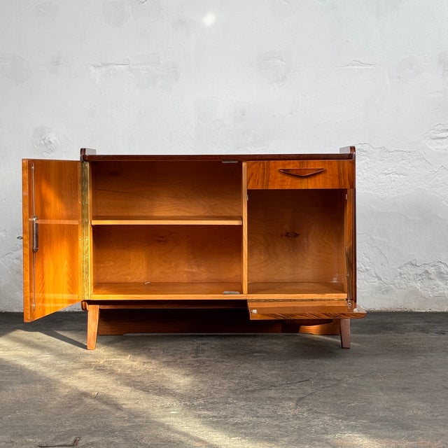 This mid-century modern sideboard cabinet is a notable piece of czechoslovakian design, created by the regarded designer...