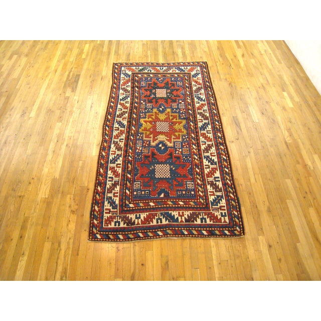 Antique Caucasian Kazak Oriental Rug, in Small Size, with Starburst Design A one-of-a-kind antique Caucasian Kazak...