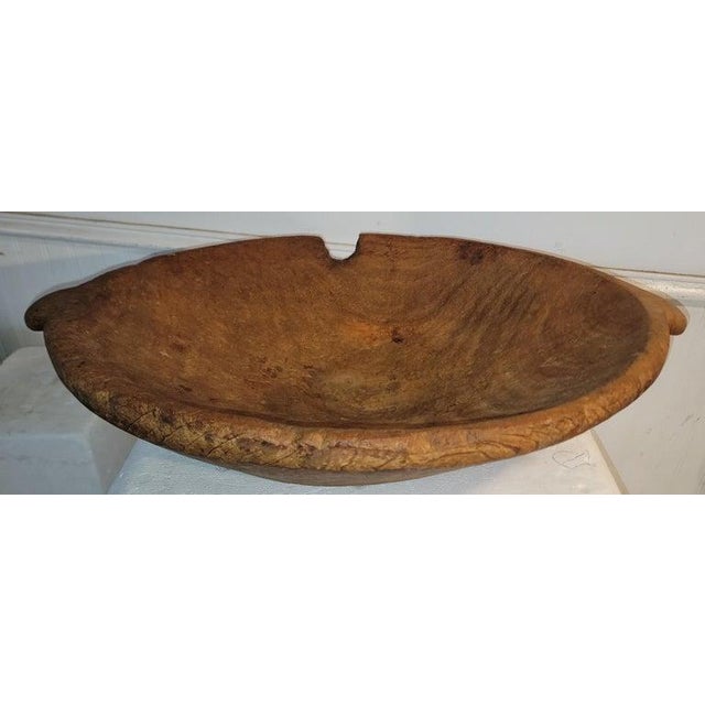 This early 19thc hand carved dough bowl is most likely Native American Indian.The carving is amazing and has a knot in the...