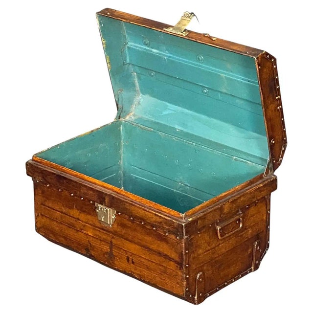 A fine English traveler's steamer trunk or coffer chest of tole or enameled tin from the 19th-century, featuring a faux-...