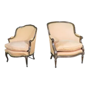 Mated Similarly Upholstered French Carved Walnut Louis Bergere Chairs - A Pair
