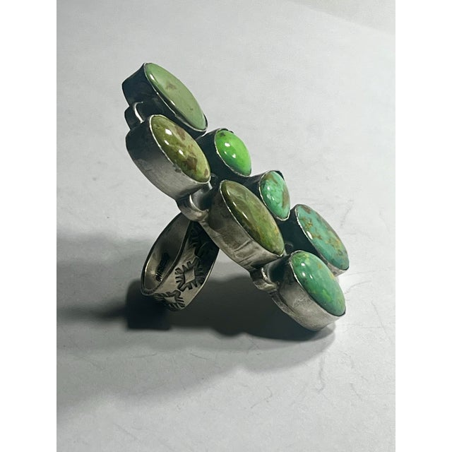 A monumental Native American statement ring seven Turquoise cabochons with sterling silver Adjustable size Signed as shown