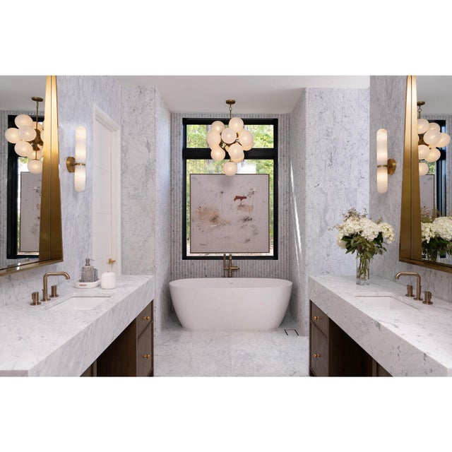 Infuse modern elegance into your home with the Salon Sconce. This deco-inspired fixture features rounded globes made of...