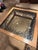 Purchased new in 2002 this beautiful square glass top wood frame coffee table has large wrought iron decorative scrollwork...