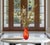 A striking hand-blown art glass vase executed in a classic Murano-style form, showcasing a vibrant blend of fiery red,...